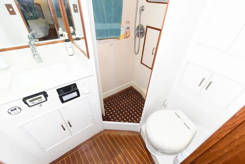 Slide: The Image of Bathroom interior of a 1990 Fleming 50 yacht with shower and wooden flooring. - 28