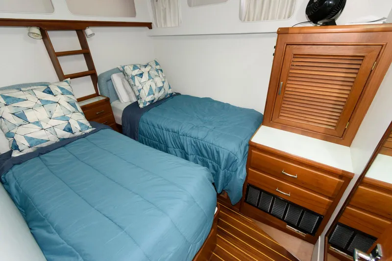 Slide: The Image of Twin cabin with blue bedding in a 1990 Fleming 50 yacht. - 29