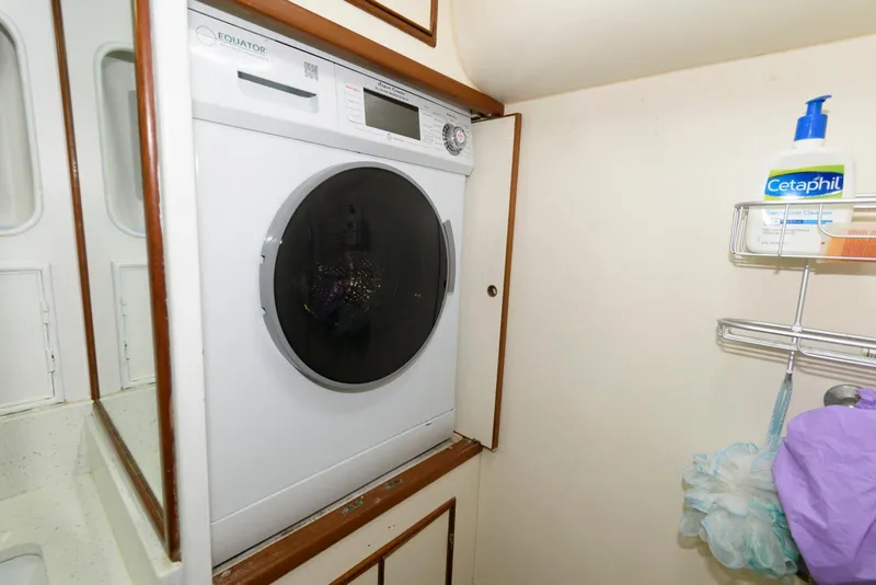 Slide: The Image of Laundry area in a 1990 Fleming 50 yacht with a washing machine. - 32