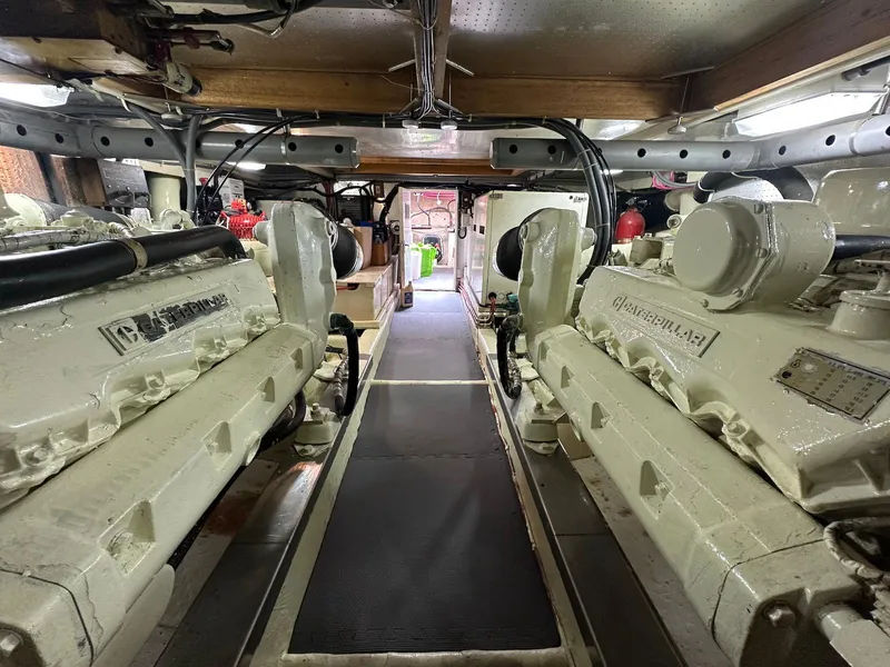 Slide: The Image of Engine room of a 1990 Fleming 50 yacht, featuring dual engines and organized layout. - 33