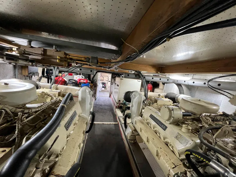 Slide: The Image of Engine room of a 1990 Fleming 50 yacht, showcasing dual engines and mechanical components. - 34
