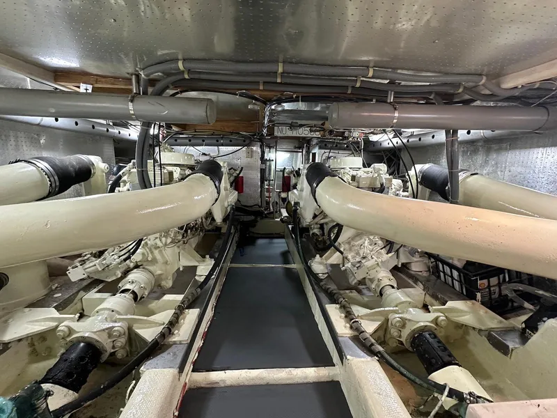 Slide: The Image of Engine room of a 1990 Fleming 50 yacht, showcasing dual engines and mechanical systems. - 35