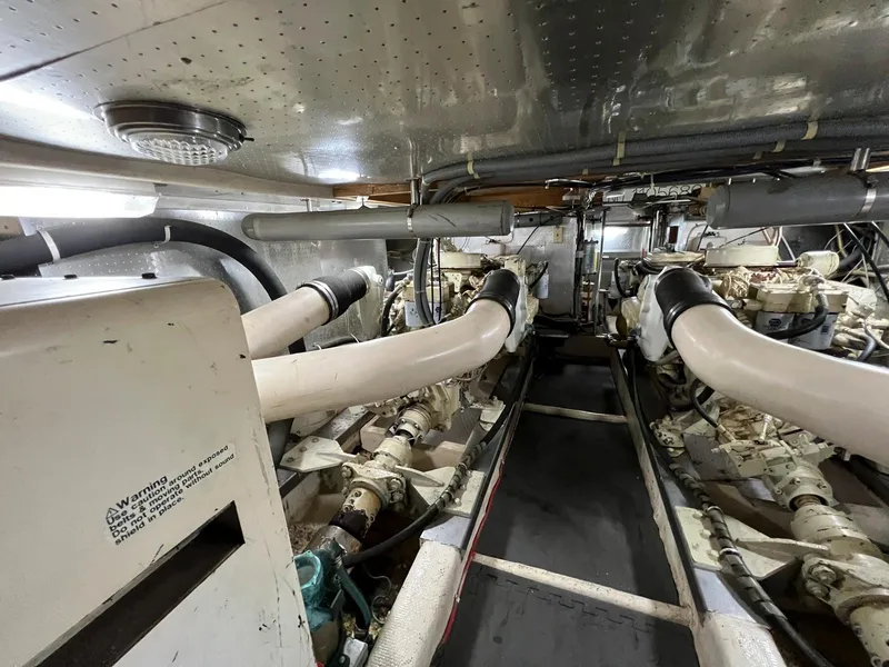 Slide: The Image of Engine room of a 1990 Fleming 50 yacht, showcasing dual engines and exhaust systems. - 36