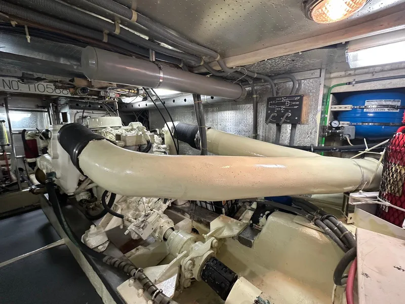 Slide: The Image of Engine room of a 1990 Fleming 50 yacht, showcasing mechanical components and piping. - 37
