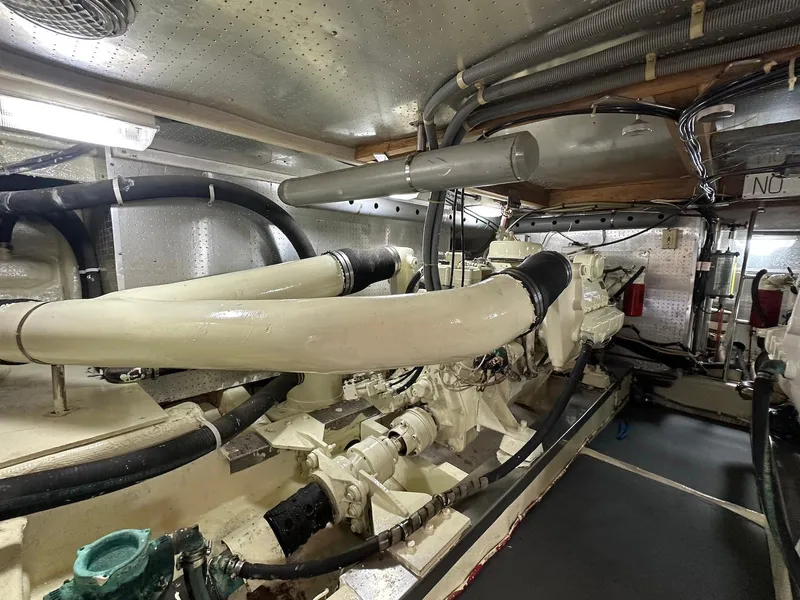 Slide: The Image of Engine room of a 1990 Fleming 50 yacht, showcasing pipes and machinery. - 38