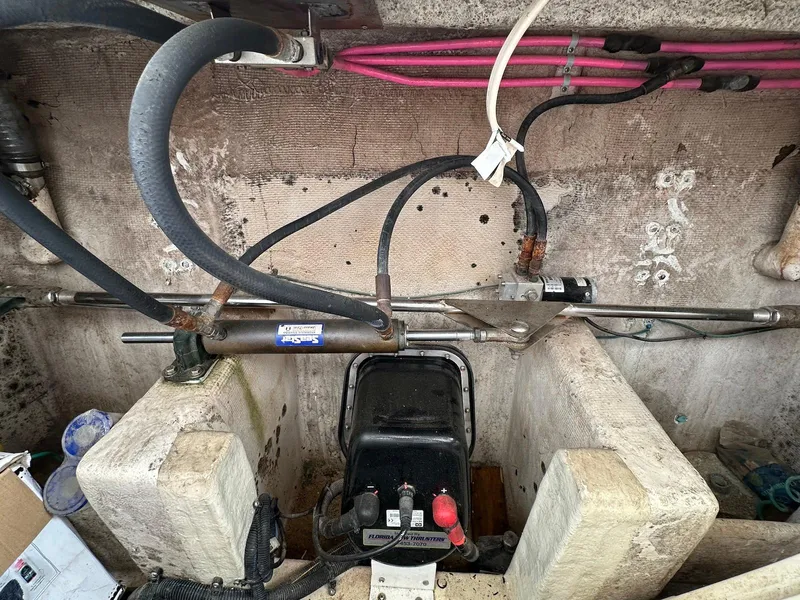 Slide: The Image of Engine compartment of a 1990 Fleming 50 boat, showing hydraulic and electrical components. - 41