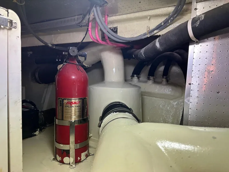 Slide: The Image of Engine room of 1990 Fleming 50 yacht with fire extinguisher and piping. - 47