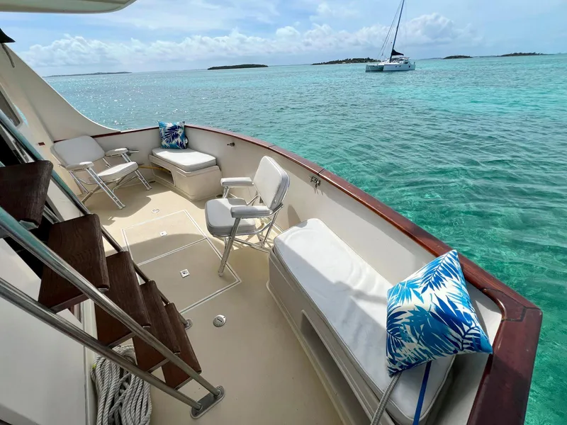 Slide: The Image of Luxurious 1990 Fleming 50 yacht deck with seating, overlooking turquoise ocean waters. - 5