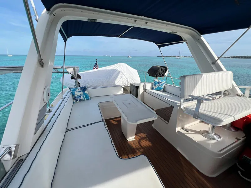 Slide: The Image of Spacious deck of a 1990 Fleming 50 yacht with seating, table, and ocean view. - 7