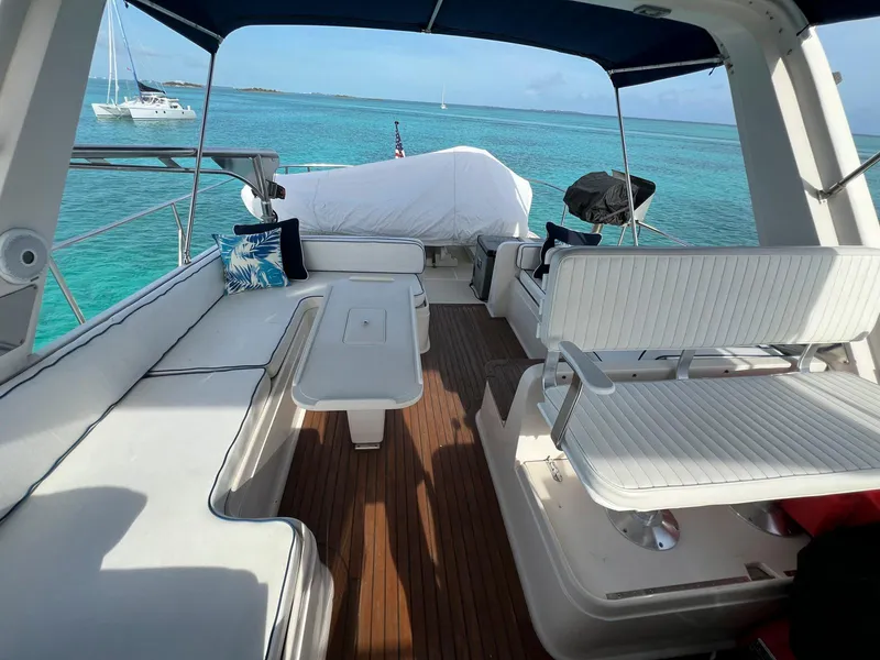 Slide: The Image of Spacious deck of a 1990 Fleming 50 yacht with seating, overlooking turquoise waters. - 8
