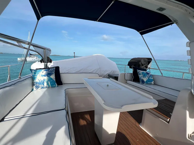 Slide: The Image of Luxurious 1990 Fleming 50 yacht deck with seating, table, and ocean view. - 9