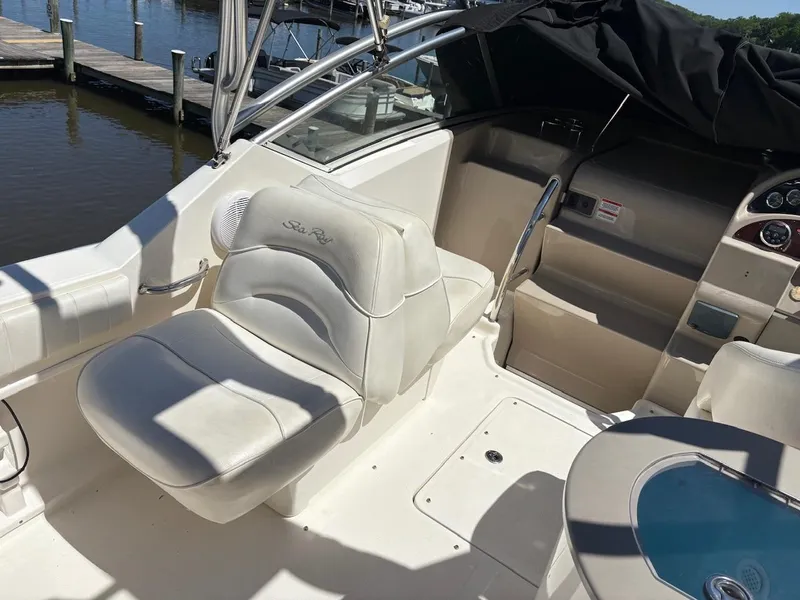 Slide: The Image of 2007 Sea Ray 270 Amberjack boat interior with white seating and steering wheel. - 10