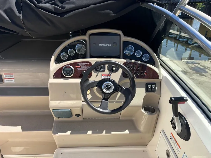 Slide: The Image of 2007 Sea Ray 270 Amberjack boat dashboard with steering wheel and navigation instruments. - 12
