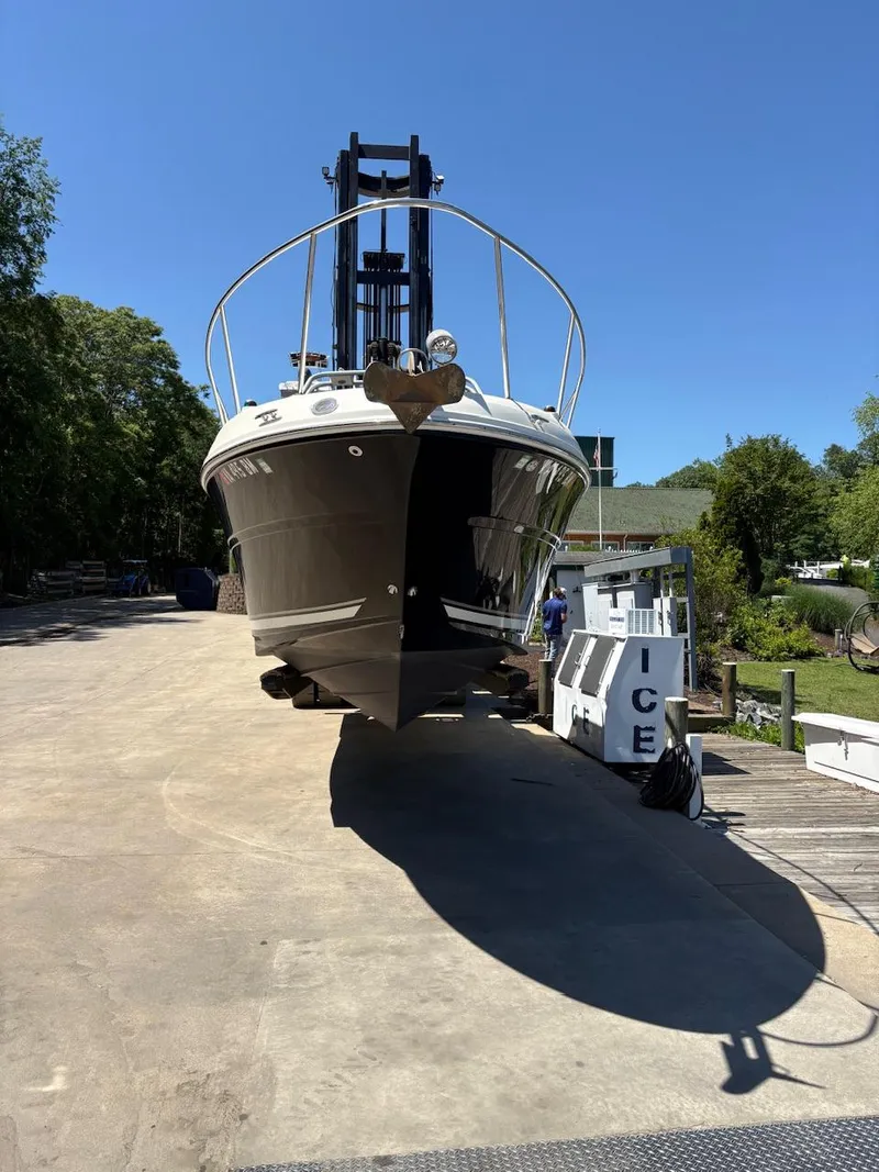 Slide: The Image of 2007 Sea Ray 270 Amberjack boat on lift, sunny day, dockside view. - 13