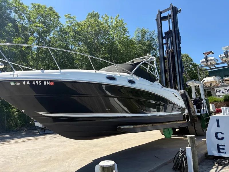 Slide: The Image of 2007 Sea Ray 270 Amberjack boat lifted by forklift at marina. - 2