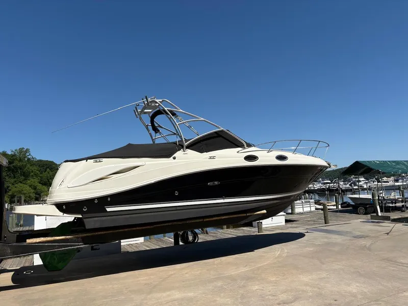 Slide: The Image of 2007 Sea Ray 270 Amberjack boat on a lift at a marina. - 3