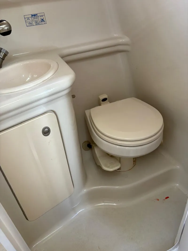 Slide: The Image of 2007 Sea Ray 270 Amberjack boat bathroom with compact sink and toilet. - 5