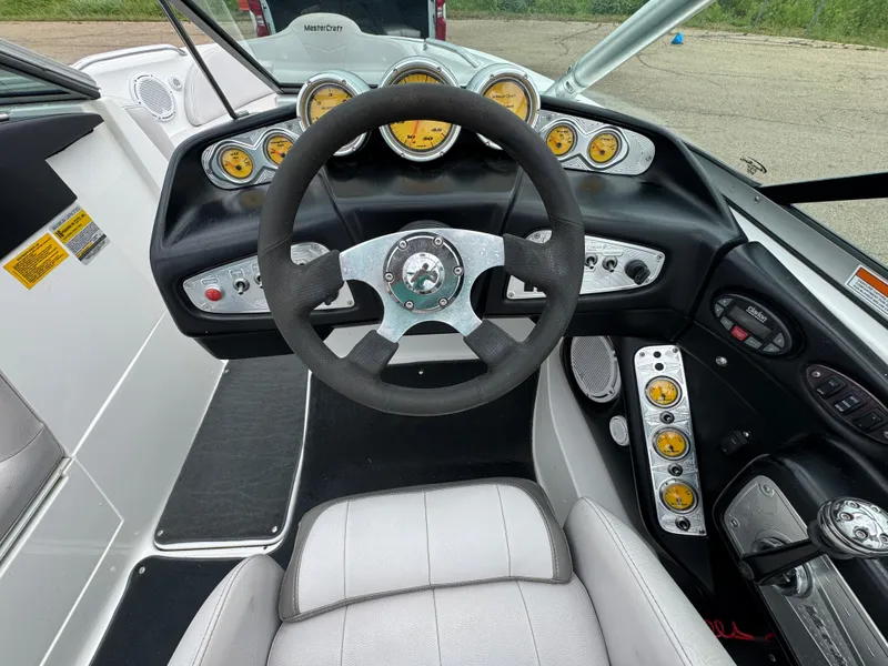 Slide: The Image of 2006 MasterCraft X30 boat dashboard with steering wheel and instrument gauges. - 10