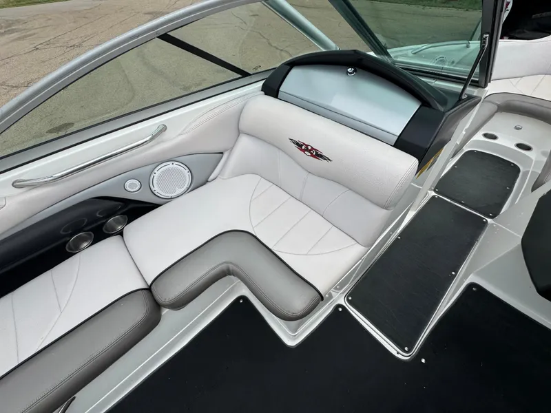 Slide: The Image of 2006 MasterCraft X30 boat interior with white and gray seating and dashboard. - 12