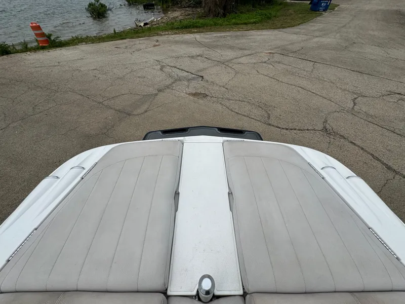 Slide: The Image of 2006 MasterCraft X30 boat at a lakeside launch ramp. - 16