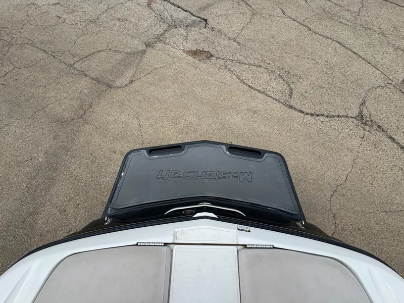 Slide: The Image of 2006 MasterCraft X30 boat rear view on cracked pavement. - 17