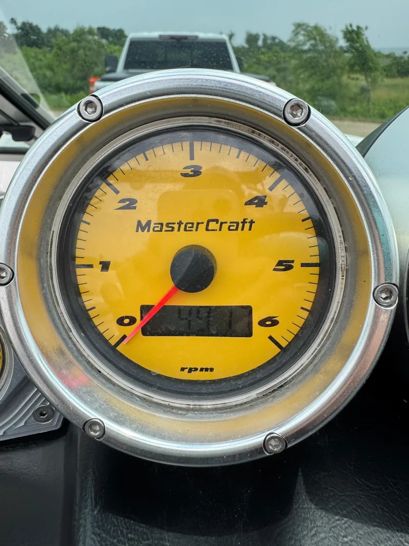 Slide: The Image of Close-up of a 2006 MasterCraft X30 boat tachometer with yellow face. - 20