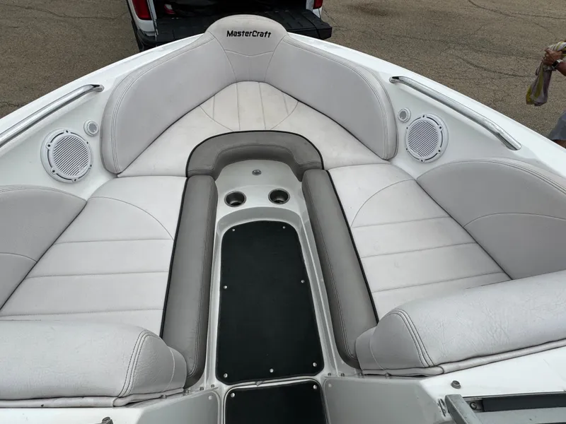Slide: The Image of 2006 MasterCraft X30 boat interior with white seating and built-in speakers. - 5