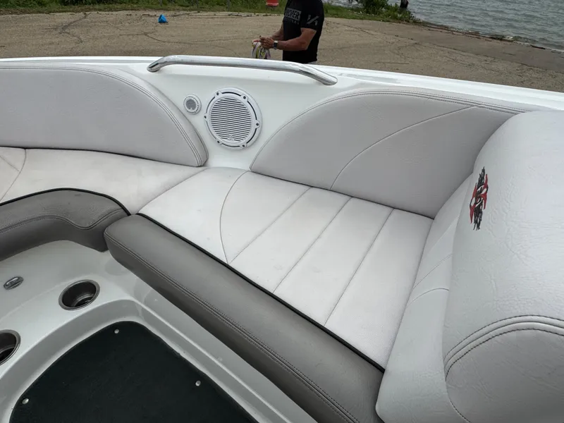 Slide: The Image of 2006 MasterCraft X30 boat interior with white and gray seating, speaker, and lake view. - 7