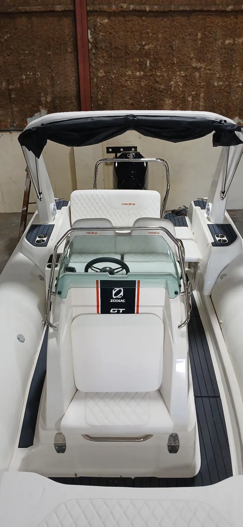 Slide: The Image of 2025 Zodiac Medline 7.5 GT boat interior with steering wheel and seating. - 10