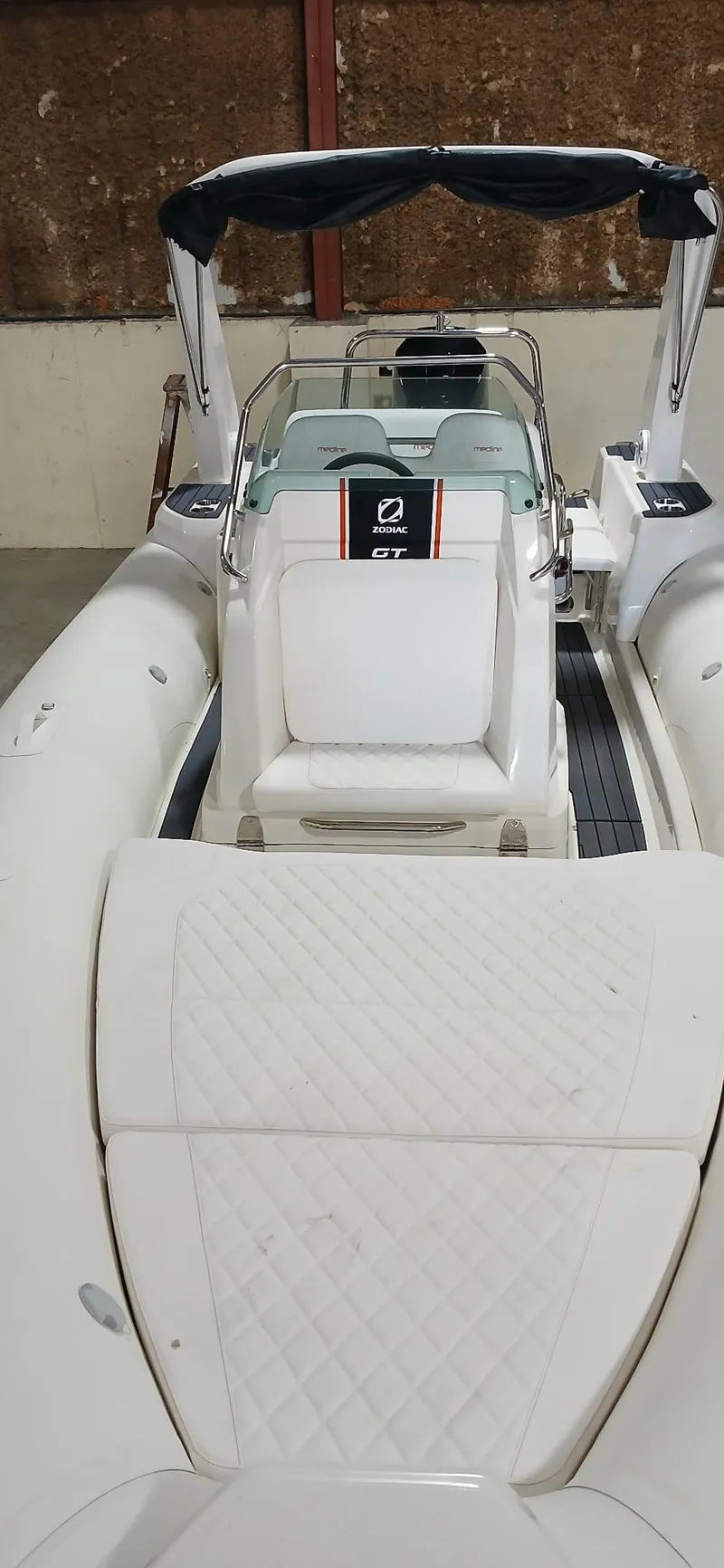 Slide: The Image of 2025 Zodiac Medline 7.5 GT boat interior with seating and steering console. - 11