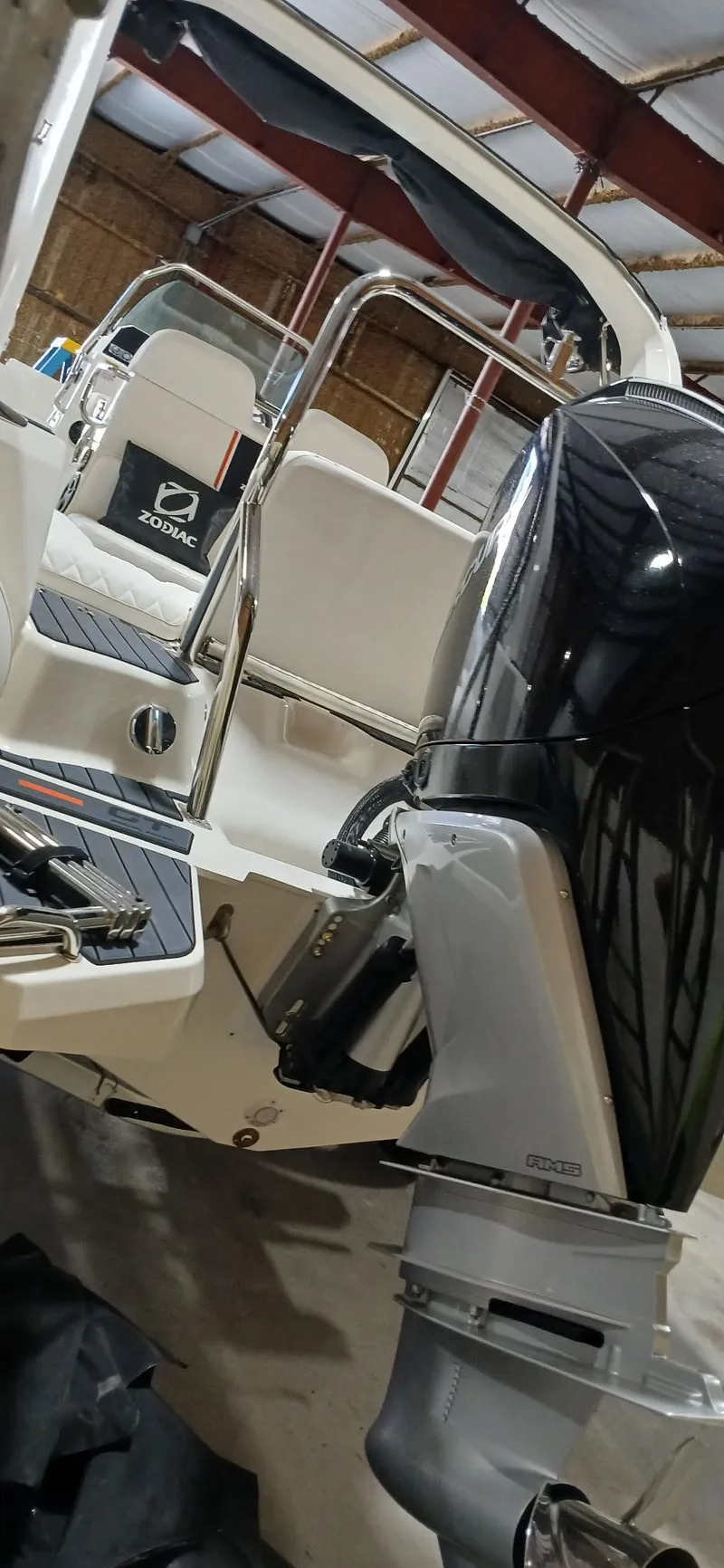 Slide: The Image of 2025 Zodiac Medline 7.5 GT boat with powerful outboard motor in a storage facility. - 12