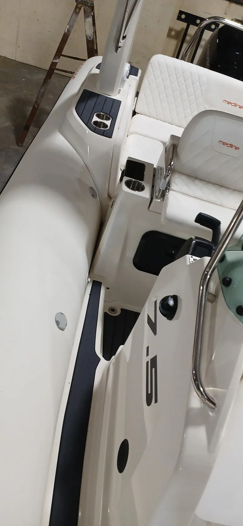 Slide: The Image of 2025 Zodiac Medline 7.5 GT boat interior with white seating and sleek design. - 9