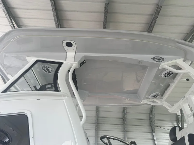Slide: The Image of 2025 Tidewater 3100 Carolina Bay boat under a metal roof, showcasing its sleek design. - 11