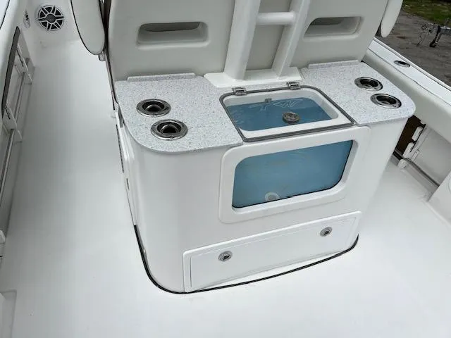 Slide: The Image of 2025 Tidewater 3100 Carolina Bay boat interior with rod holders and storage compartments. - 2
