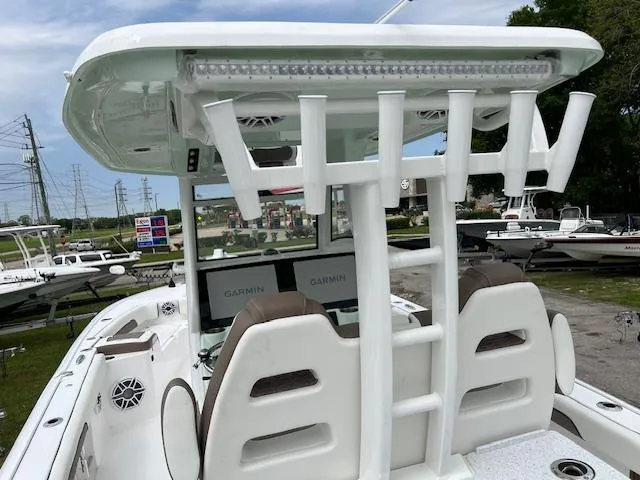 Slide: The Image of 2025 Tidewater 3100 Carolina Bay boat with dual Garmin displays and rod holders. - 3