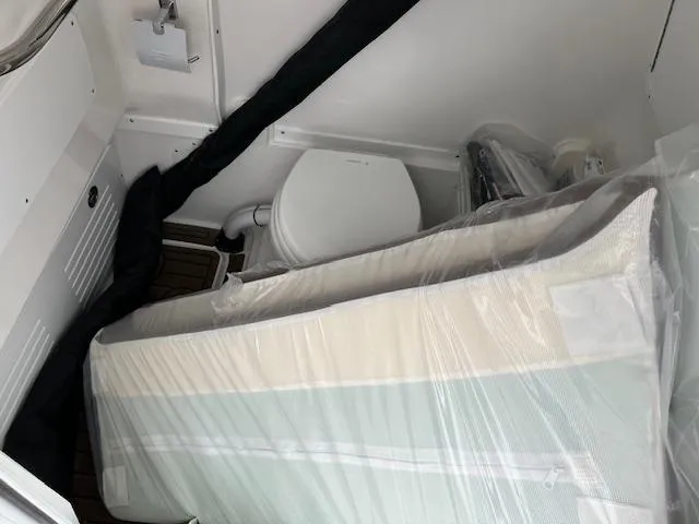 Slide: The Image of 2025 Tidewater 3100 Carolina Bay interior with toilet and wrapped cushions. - 8