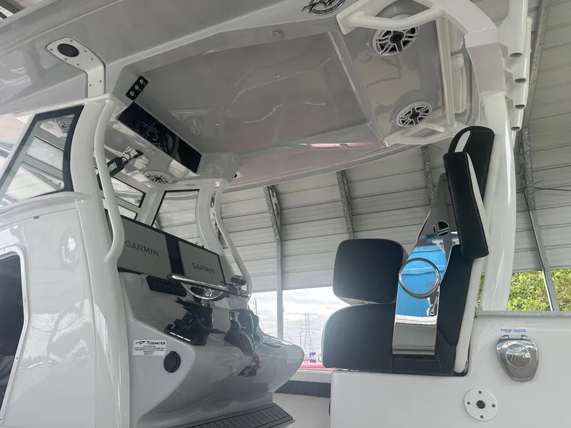 Slide: The Image of 2025 Tidewater 3100 Carolina Bay boat interior with modern helm and seating. - 9
