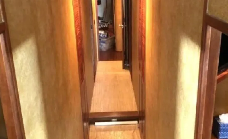 Slide: The Image of Interior hallway of 1993 Palmer Johnson Sportfish yacht with wooden accents. - 10