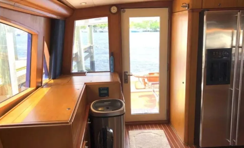 Slide: The Image of Interior of 1993 Palmer Johnson Sportfish yacht with wooden cabinetry and stainless steel appliances. - 12