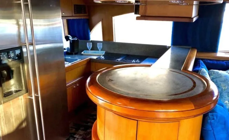 Slide: The Image of Luxurious 1993 Palmer Johnson Sportfish yacht interior with modern kitchen and elegant wood finishes. - 13