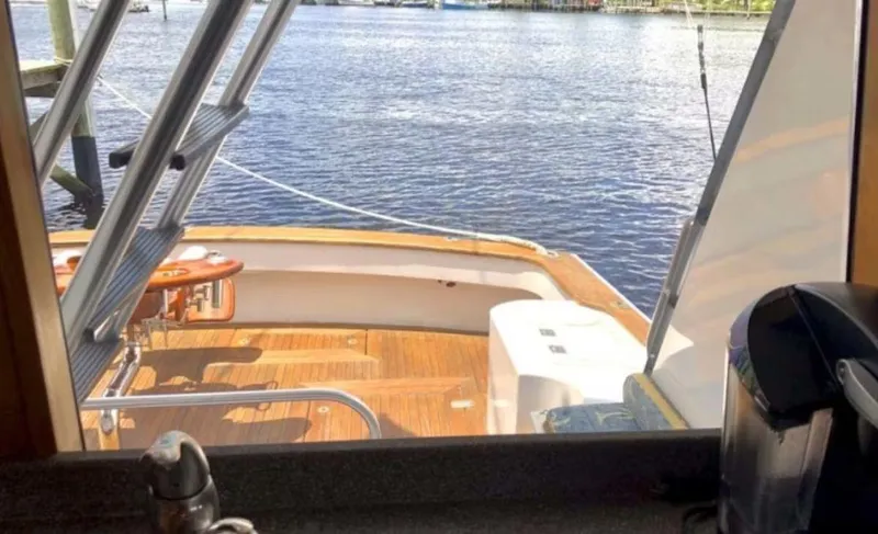 Slide: The Image of 1993 Palmer Johnson Sportfish yacht deck view from interior, overlooking calm waters. - 4