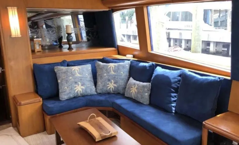 Slide: The Image of Luxurious 1993 Palmer Johnson Sportfish yacht interior with blue seating and decorative pillows. - 6