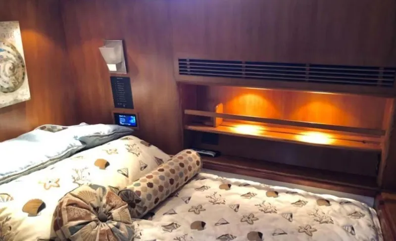 Slide: The Image of Luxurious 1993 Palmer Johnson Sportfish cabin with cozy bedding and warm wooden interior. - 9