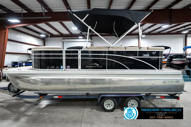 Slide: The Image of 2016 Bennington 20 SLMX pontoon boat on trailer in indoor storage facility. - 11
