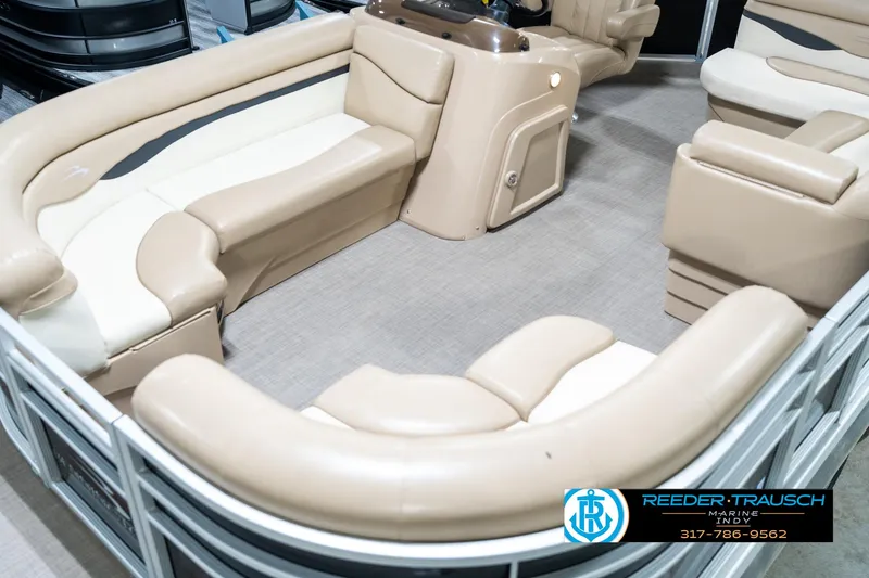 Slide: The Image of 2016 Bennington 20 SLMX pontoon boat interior with beige seating and console. - 12
