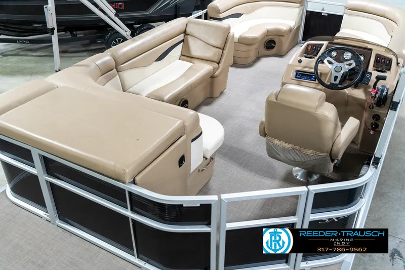 Slide: The Image of 2016 Bennington 20 SLMX pontoon boat interior with beige seating and steering console. - 14