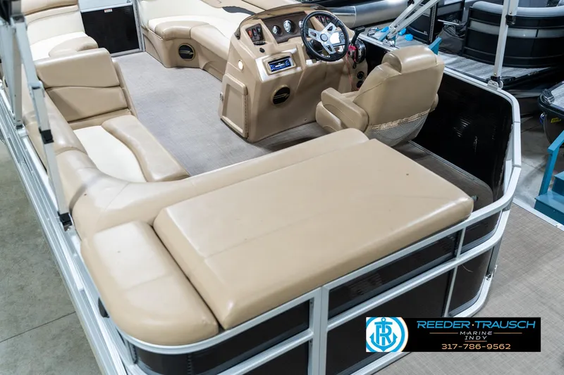 Slide: The Image of 2016 Bennington 20 SLMX pontoon boat interior with beige seating and steering console. - 15