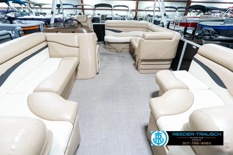 Slide: The Image of 2016 Bennington 20 SLMX pontoon boat interior with beige seating and spacious layout. - 16