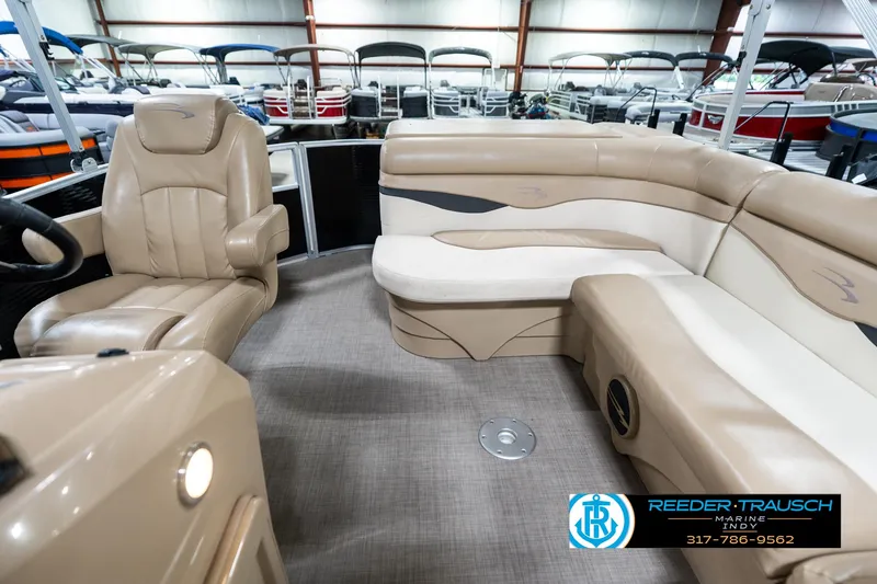 Slide: The Image of 2016 Bennington 20 SLMX pontoon boat interior with beige seating and carpeted floor. - 17