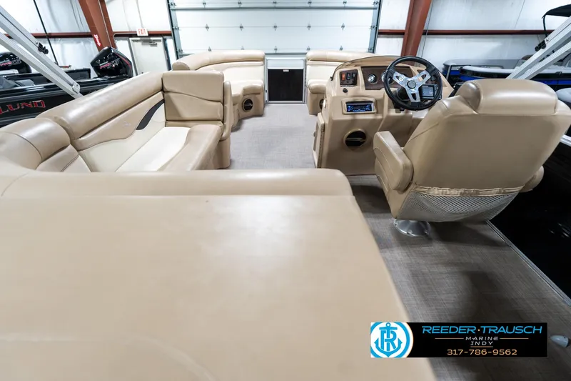 Slide: The Image of Interior of a 2016 Bennington 20 SLMX pontoon boat with beige seating and steering console. - 19